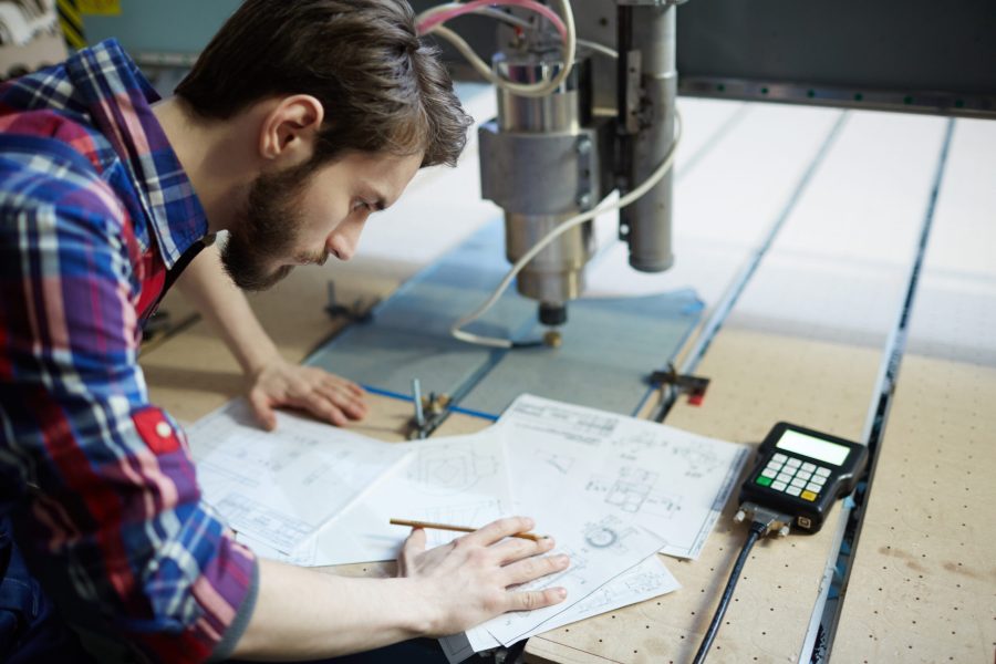 Young engineer concentrating on sketch of project